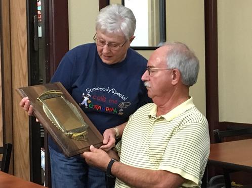 Club Secretary presenting the Carl Goldberg award to Maurie Sumption